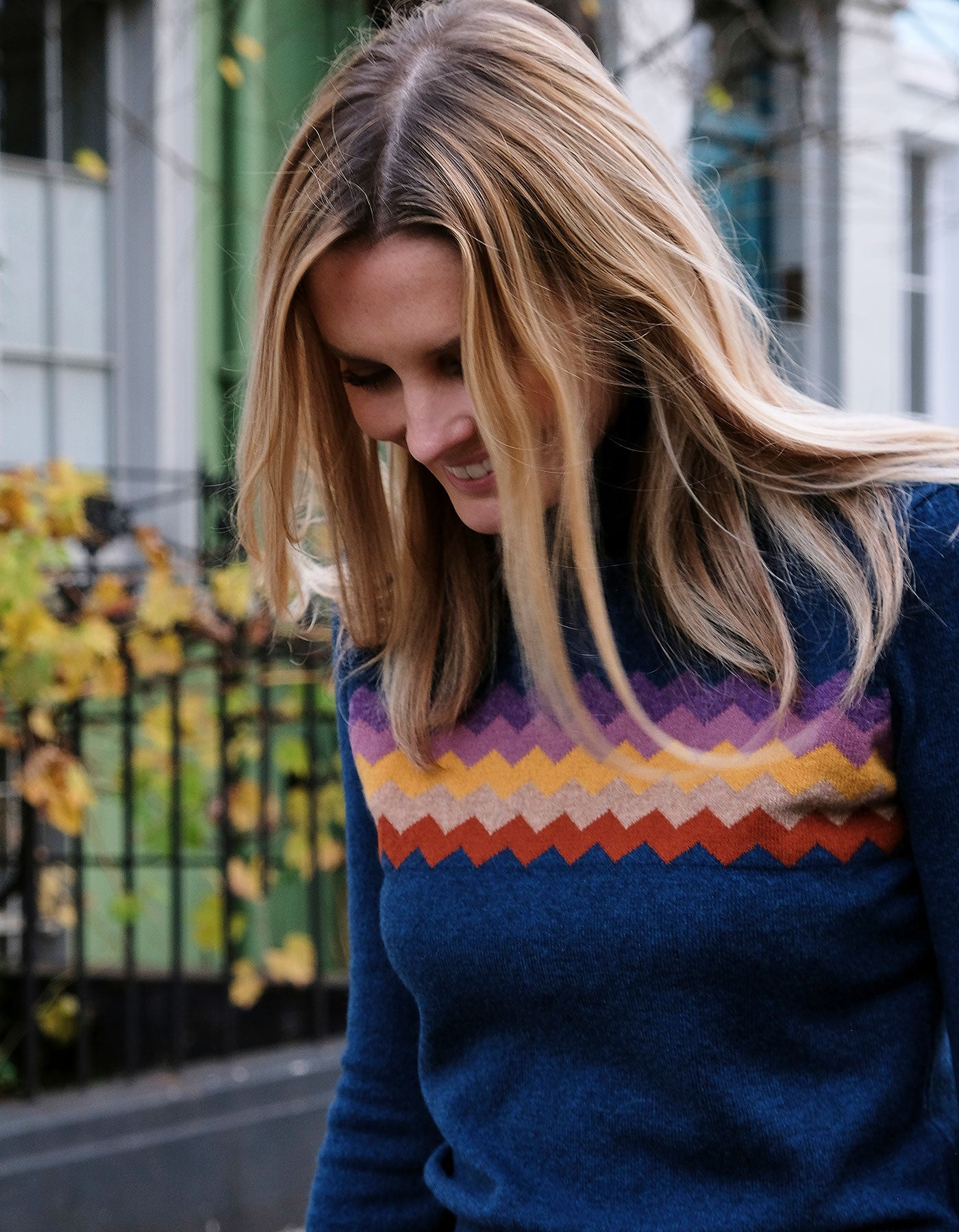 Close up of a smiling woman in malin darlin cashmere knitwear, the Zigzag Blue cashmere jumper.