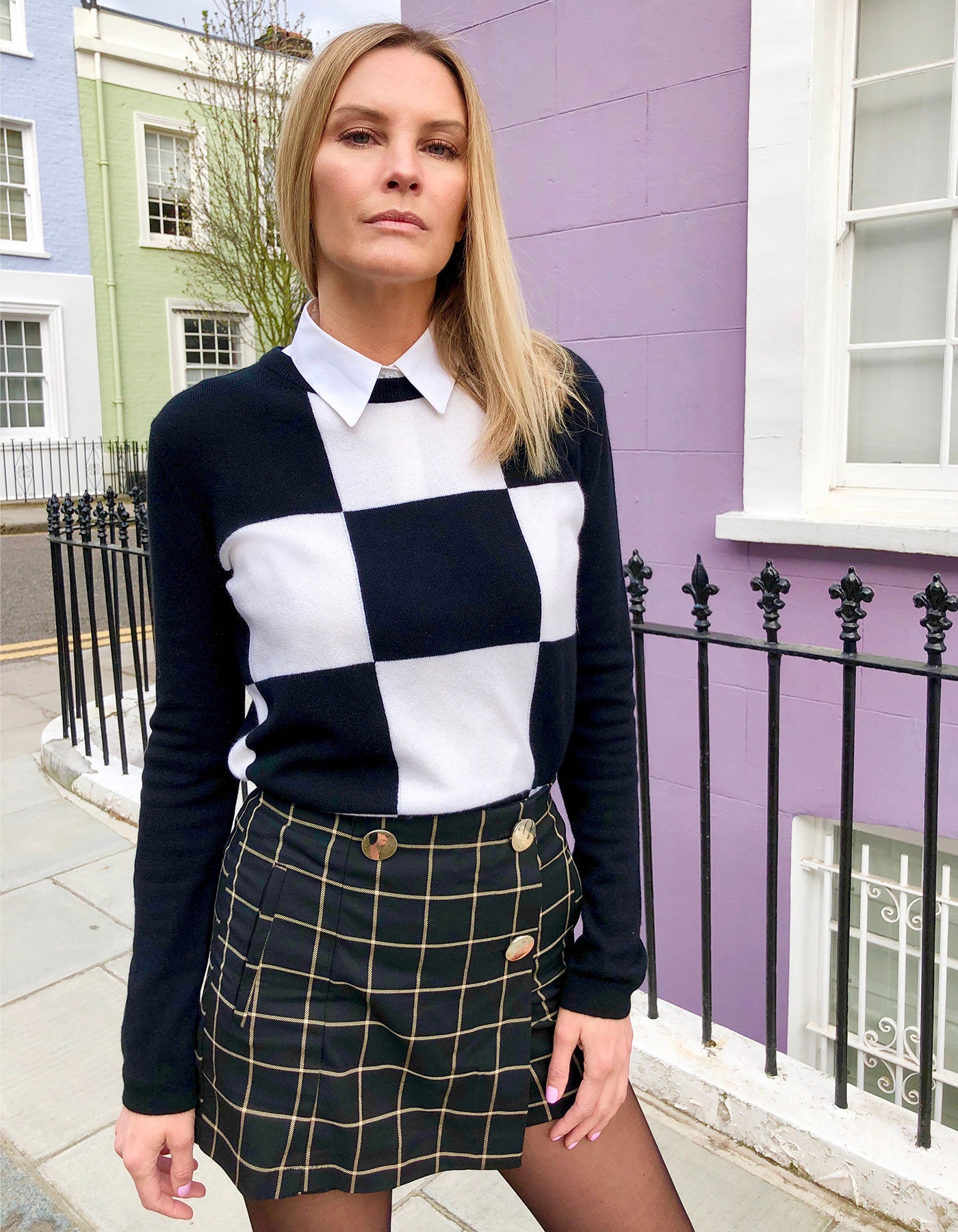 Image of a model in a city street wearing the malin darlin Gambit cashmere jumper.