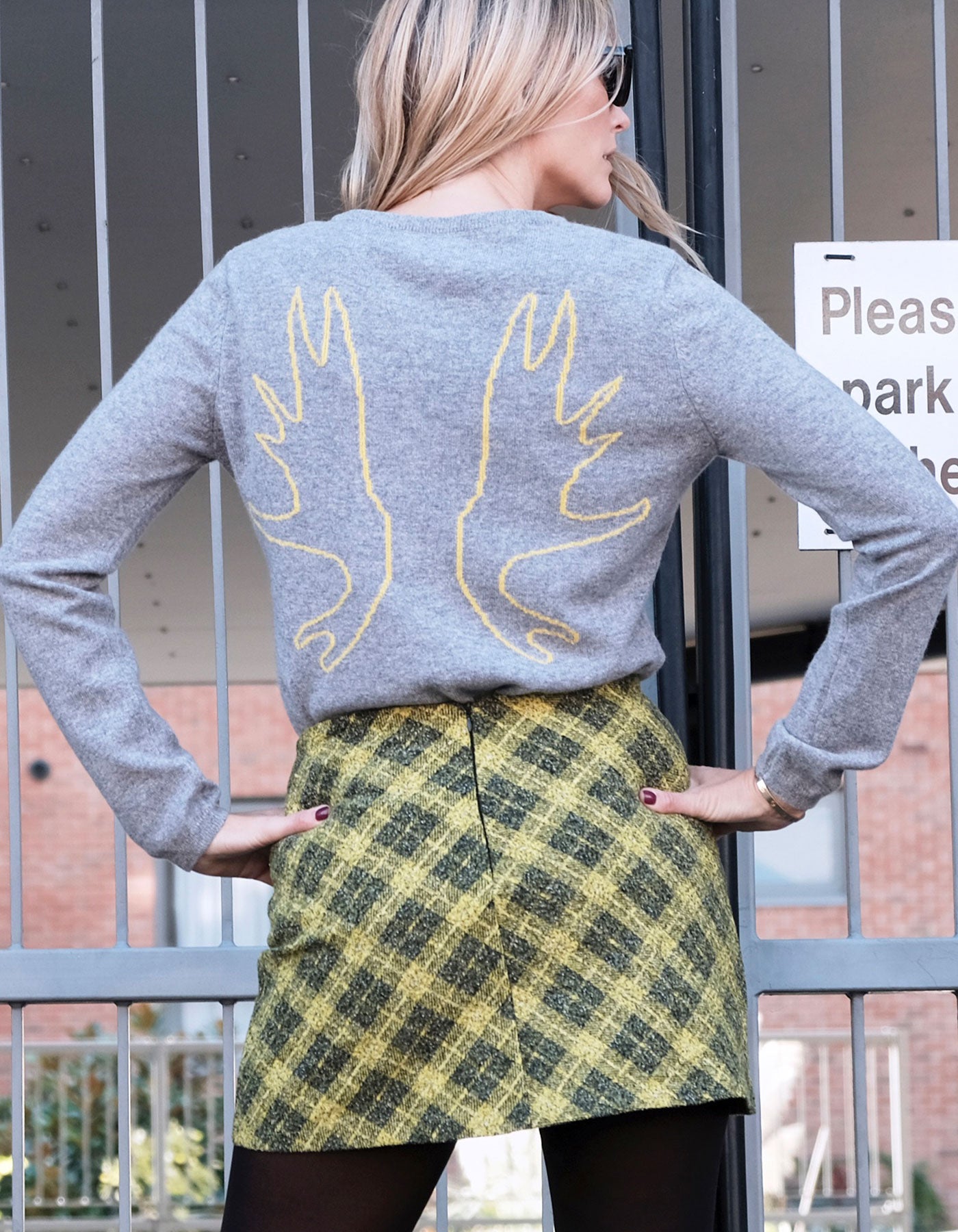 A woman wearing an Antlers cashmere Intarsia knit by Malin Darlin.