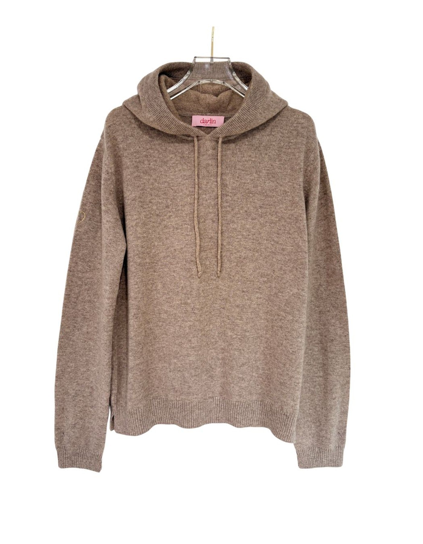 Beige hoodie on a hanger against a white background